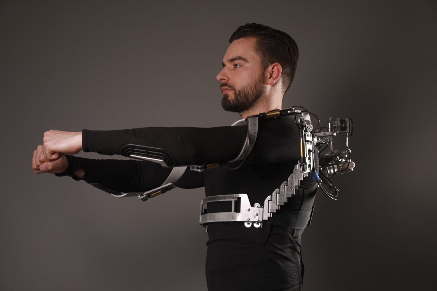 A person wearing the HumaniX mechanical exoskeleton arm